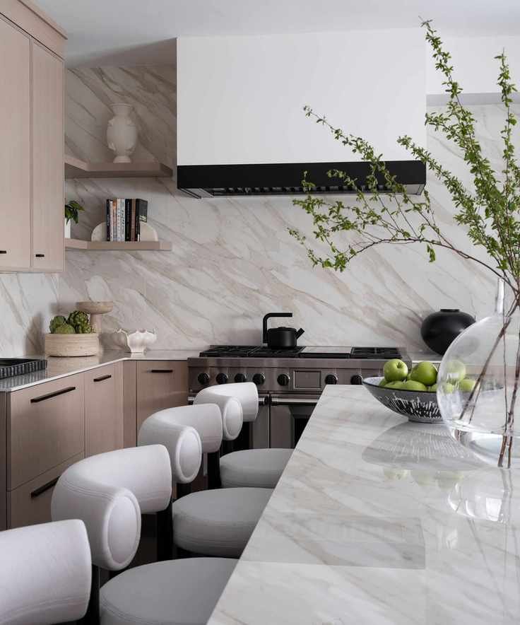 Corner of kitchen with bar stools at marble island