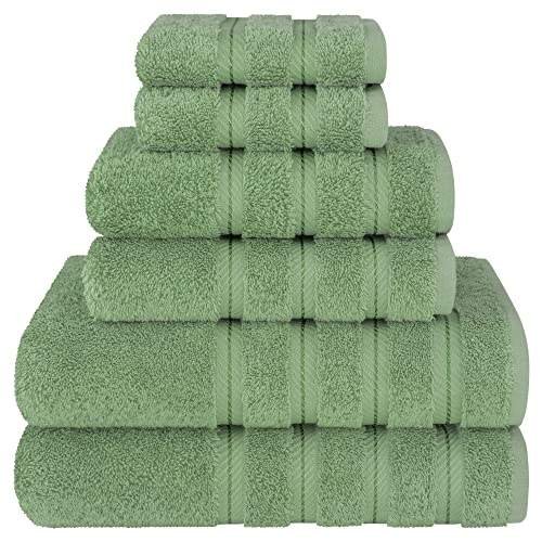 A stack of six neatly folded green cotton towels
