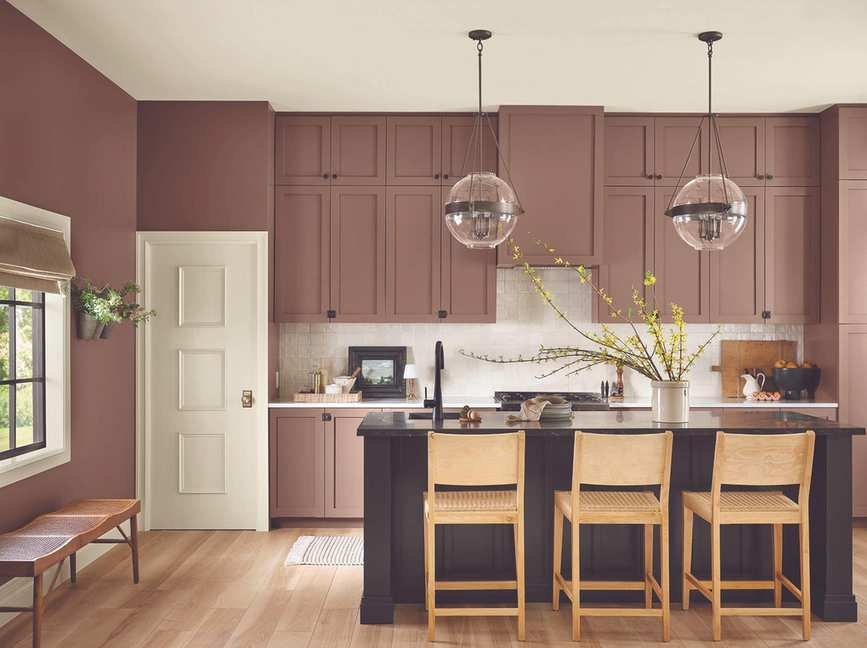 Dusty dark pink painted kitchen cabinets and hanging pendant lights