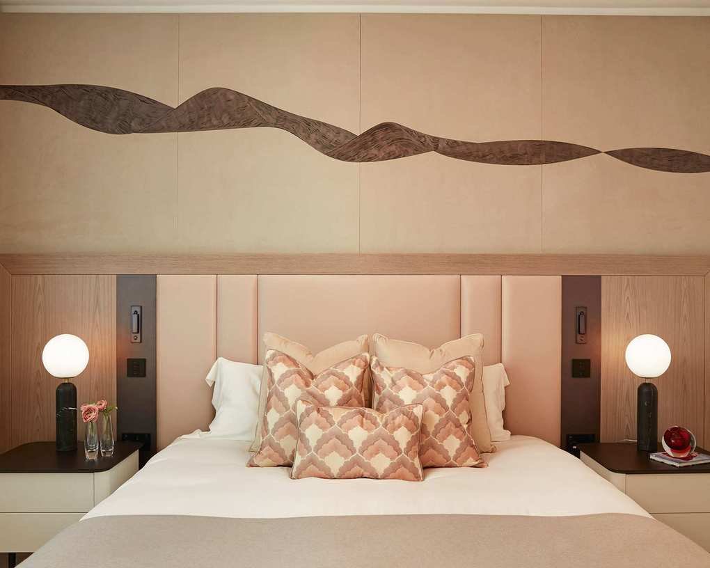 Cream bedroom with wall panels and headboard