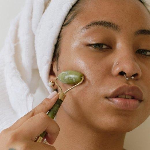 Woman using jade roller on face Woman using jade roller on face