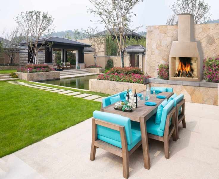 Wooden patio furniture with vibrant cushions and plates.