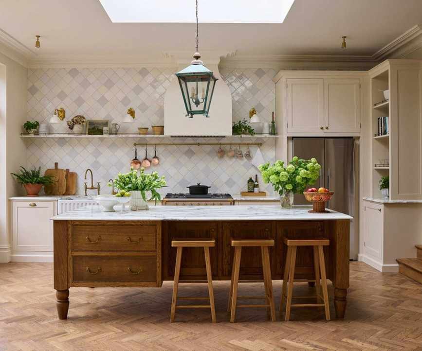 A neutral kitchen with a large wooden kitchen island