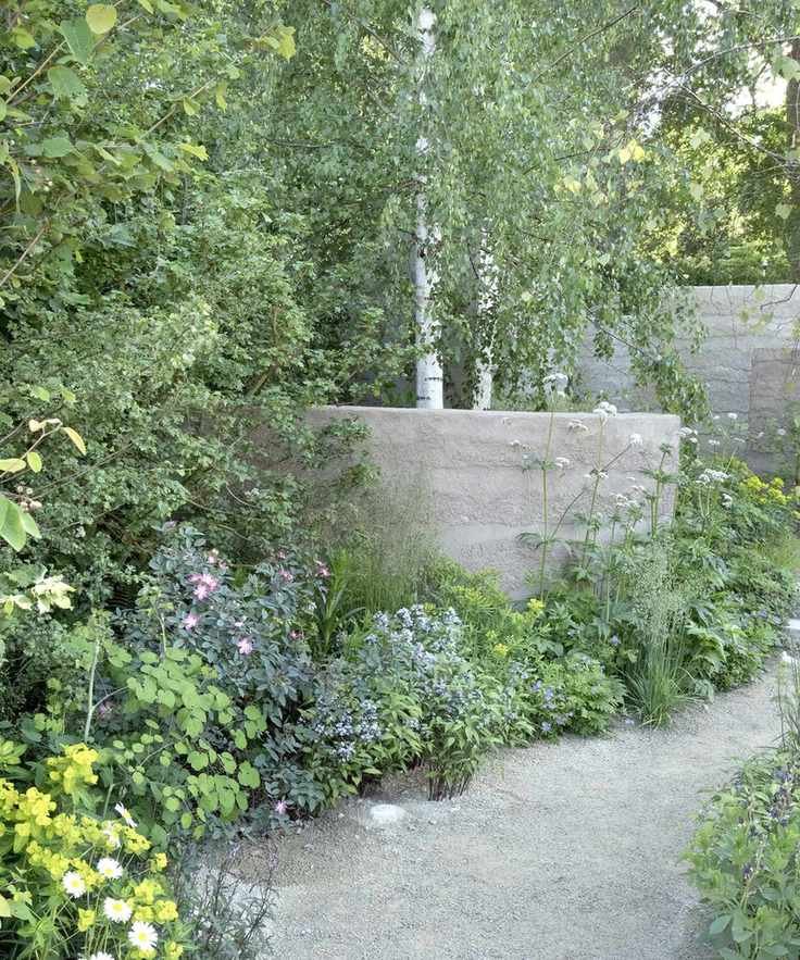 shrubs planted in a gravel garden next to a path