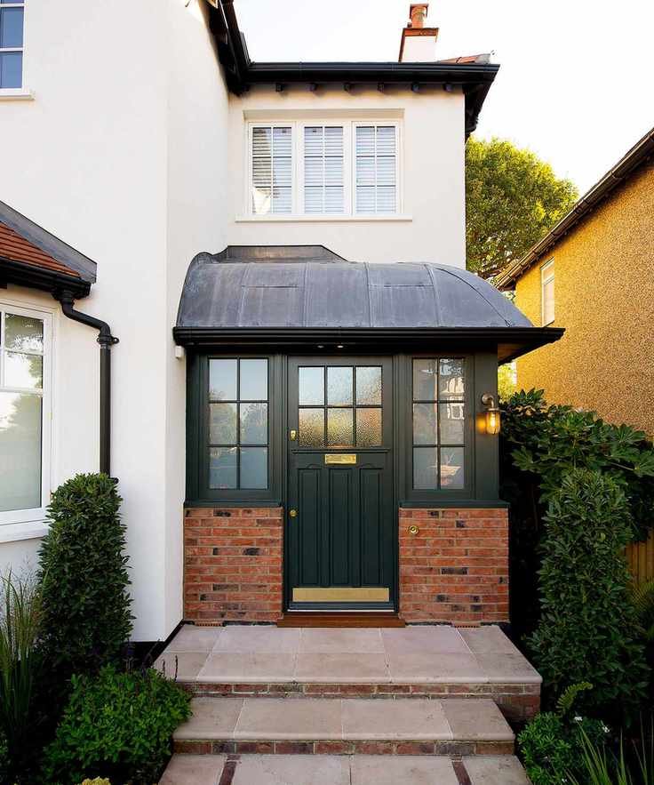 A small brick front porch on a white house