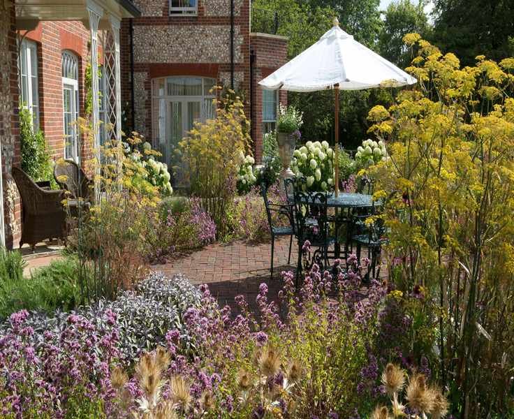 mediterranean garden ideas terrace with planting and dining area