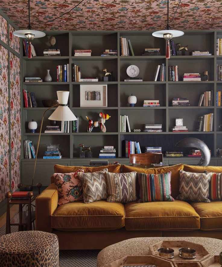 A boldly patterned living space with built-in dark wood bookshelves and a mustard sofa