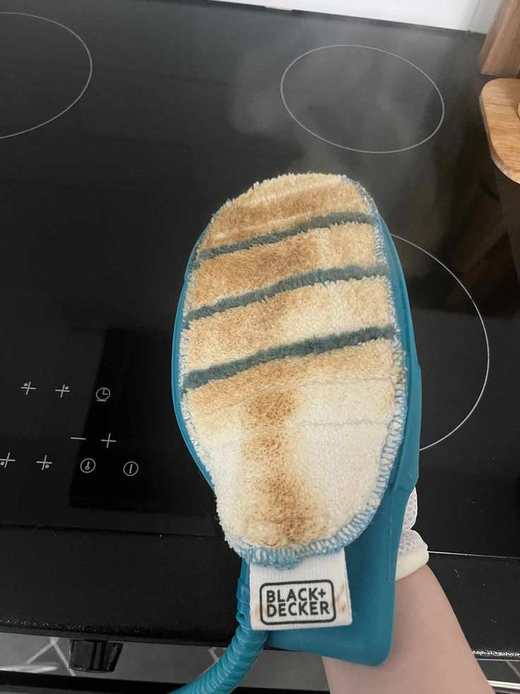 The greasy marks from an oven door on a steam cleaning mitt