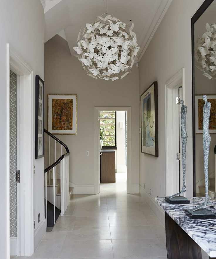 A modern hallway featuring a unique chandelier