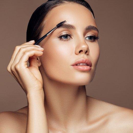 Woman Applying Oil to Brows