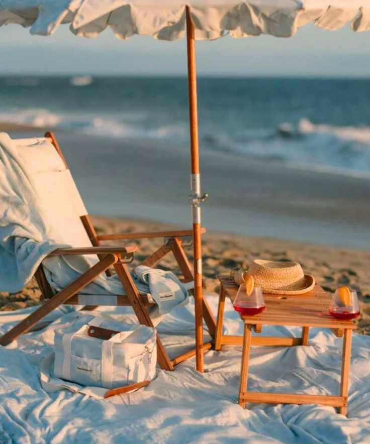 Business &amp;amp; Pleasure Co folding teak picnic table on a beach