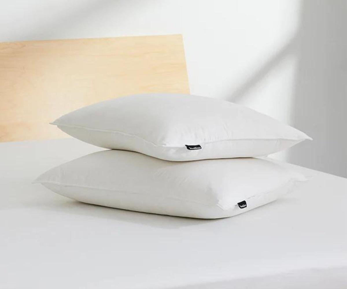 Two Brooklinen Down Pillows on a mattress.