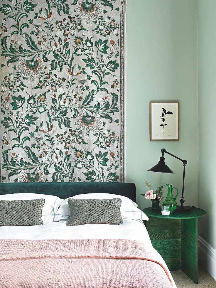 Green bedroom with a hanging fabric panel in Lewis &amp;amp; Wood's Coromandel linen