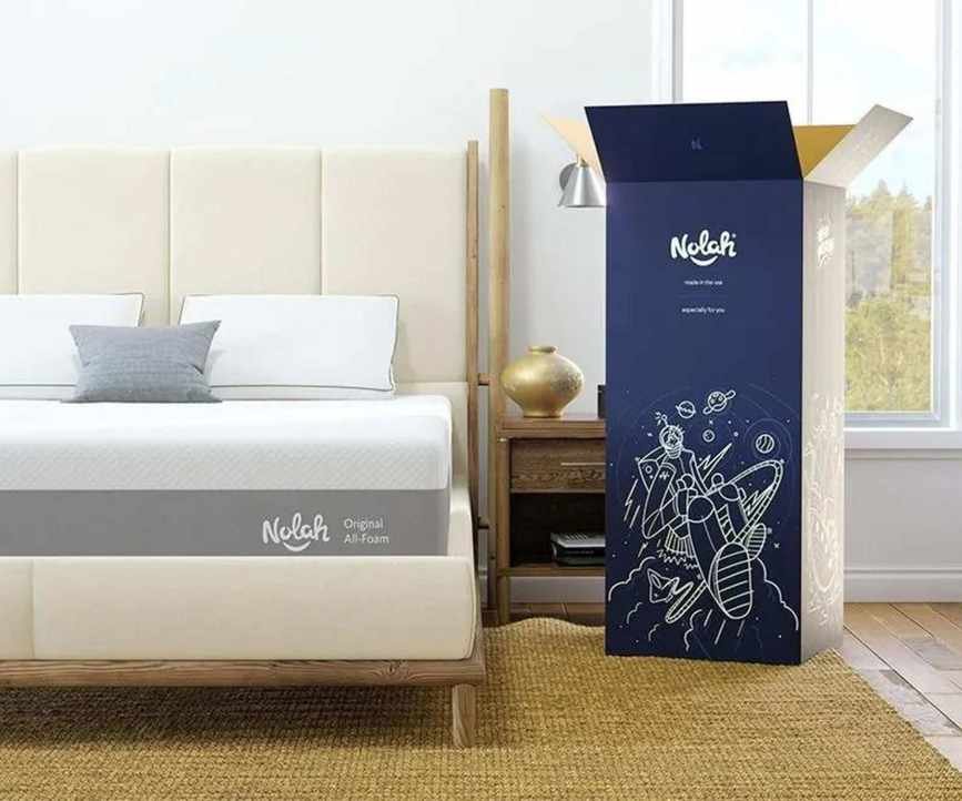 Nolah Original Mattress on a bed with its delivery box.