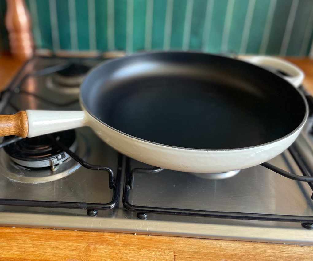 The beautiful Le Creuset Alpine Wood Pan on a gas stove