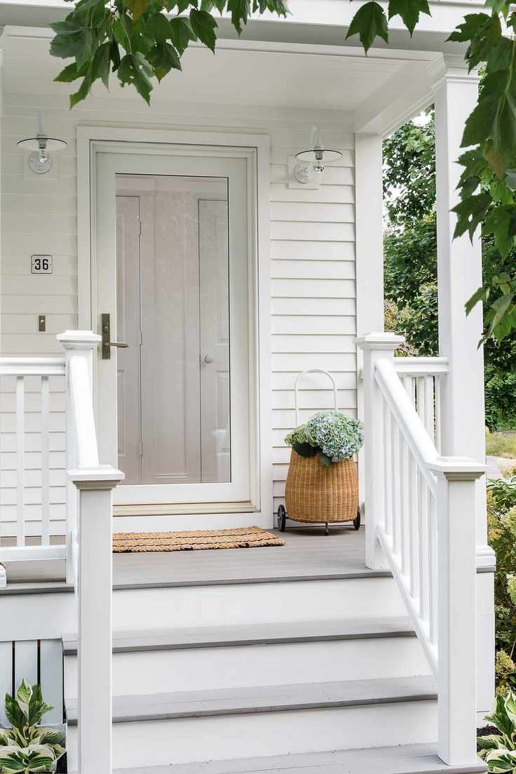 white front of country style house with outdoor lighting
