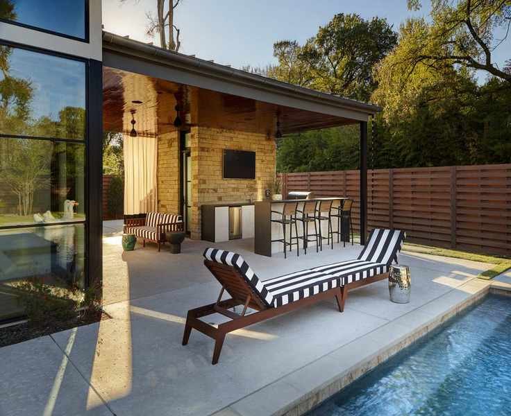 A double striped sun lounger in a modern yard with a pool.