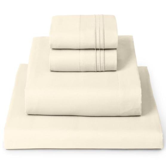 a stack of beige luxury bedding folded up into a neat pile