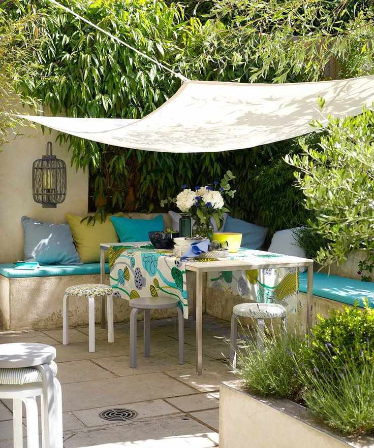 Corner patio with built-in seating and colorful decor.