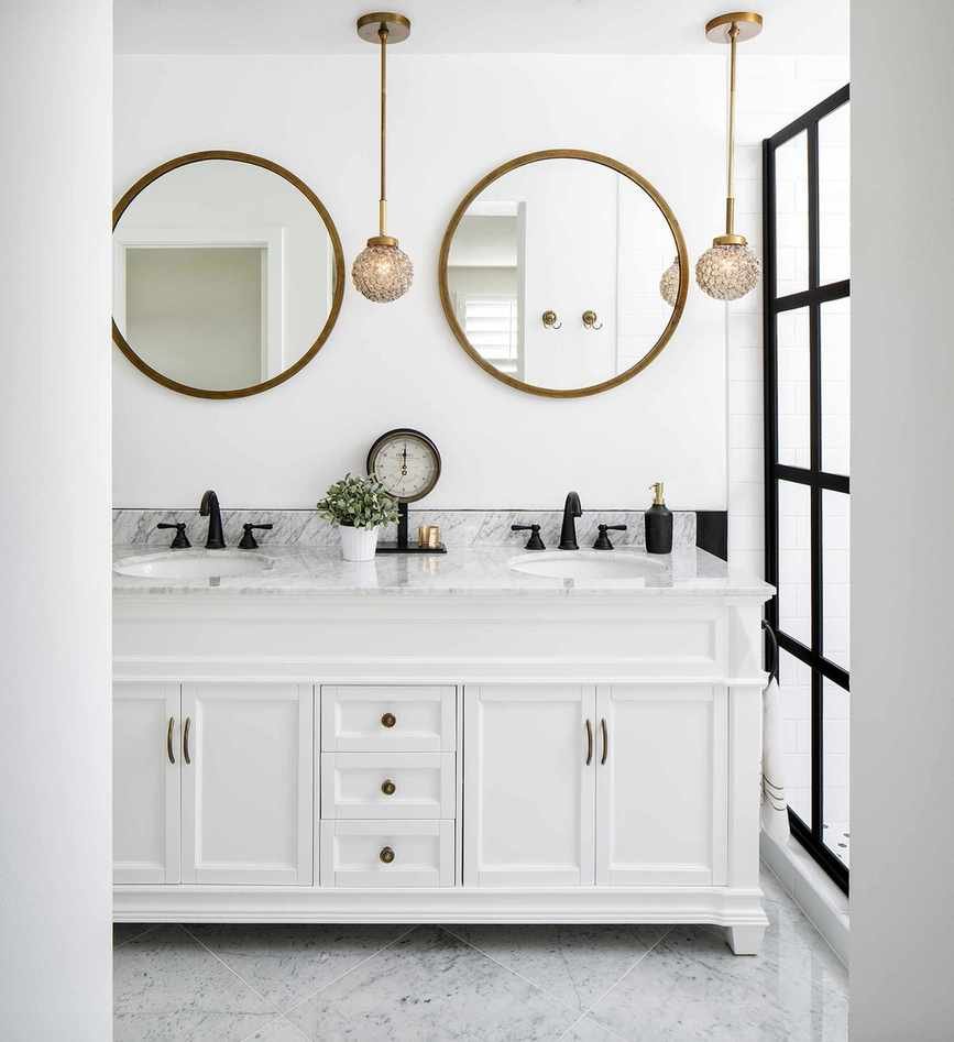 White bathroom featuring a white vanity unit and marble countertop