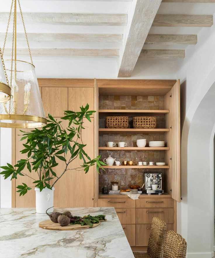 Wooden kitchen with white marble countertops and rustic fixtures