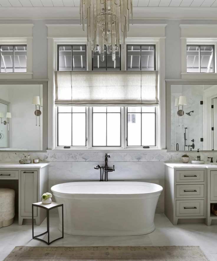 Elegant bathroom featuring a freestanding bath and chandelier