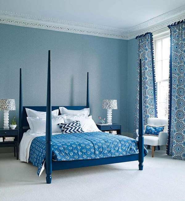 An example of bed ideas showing a blue four-poster bed in a blue bedroom