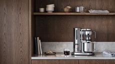 The Aarke coffee maker in a modern, wood kitchen