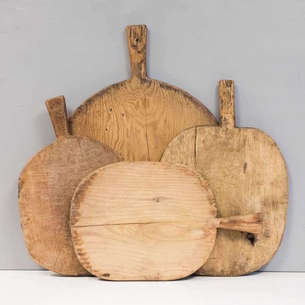 Four different shaped wooden serving boards with handles