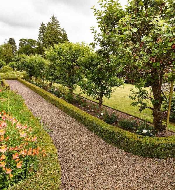 Long garden with gravel pathways and hedges