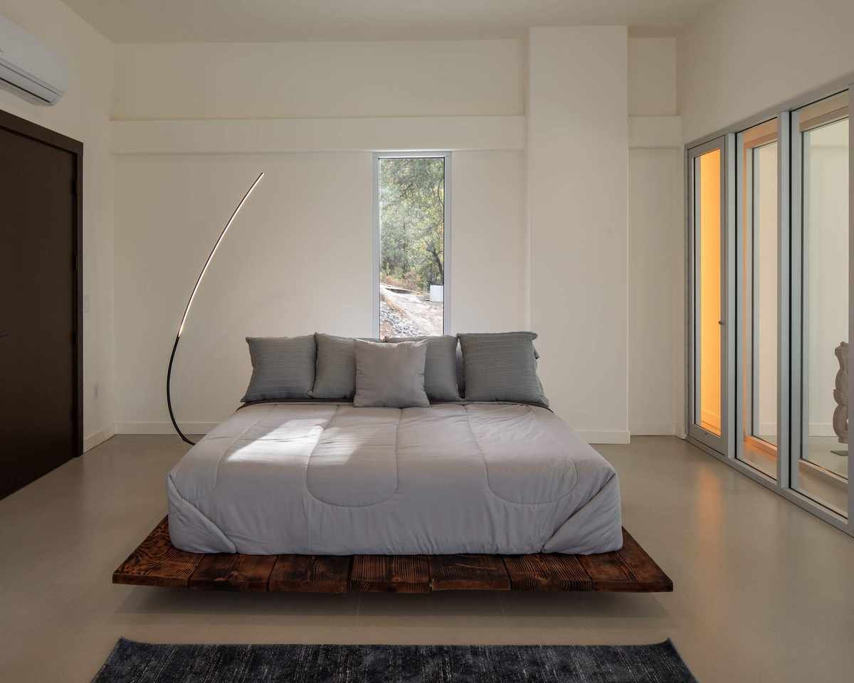 Brutalist bedroom featuring concrete details and wood accents