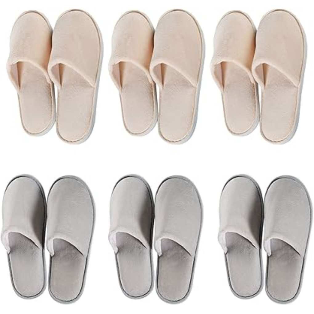 Three pairs of pink slippers above three pairs of grey slippers