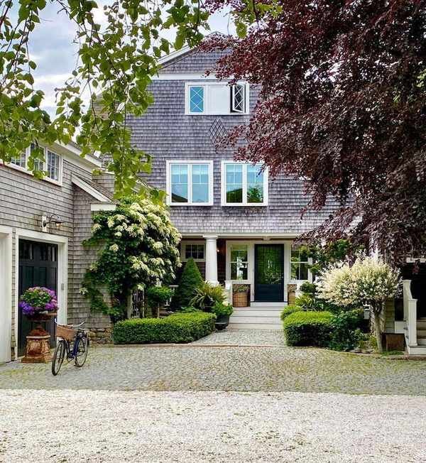 Shingle style home with columns, side garage and porch