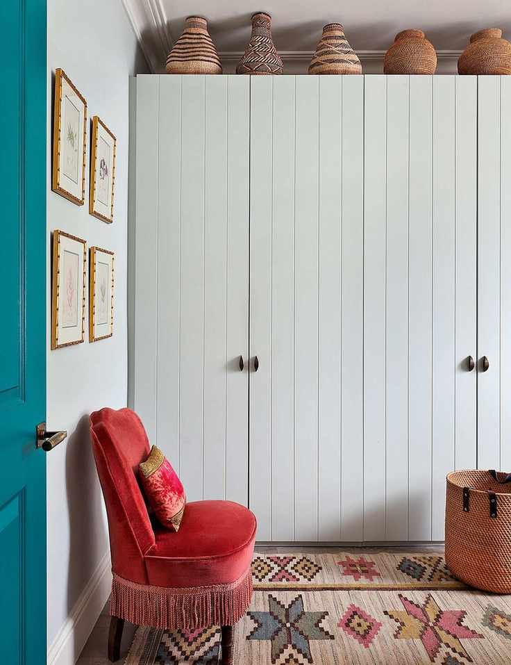 Small bedroom storage with white painted wardrobe and patterned rug