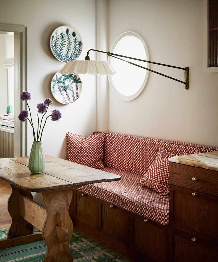 dining nook with rustic antique wooden table and upholstered bench seat