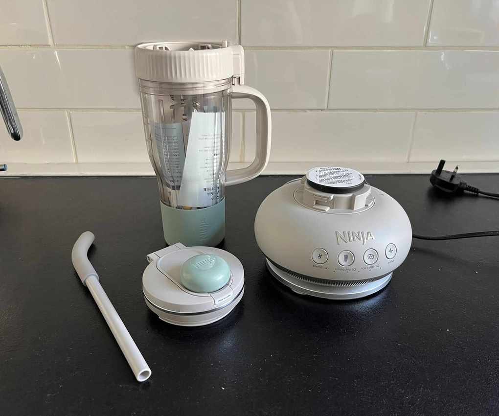 All parts of a grey Ninja BlendBoss on a black counter.