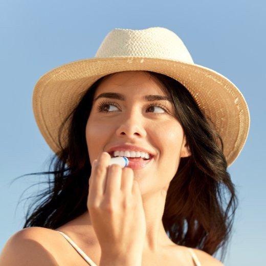 Image of model applying lip care on their lips
