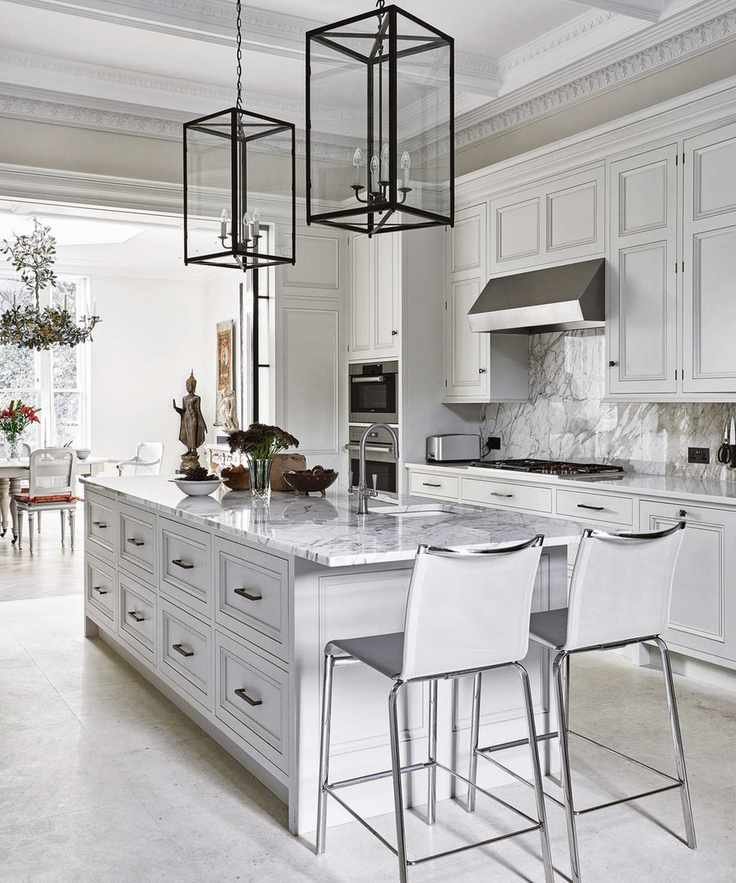 Chic white kitchen with marble-topped island