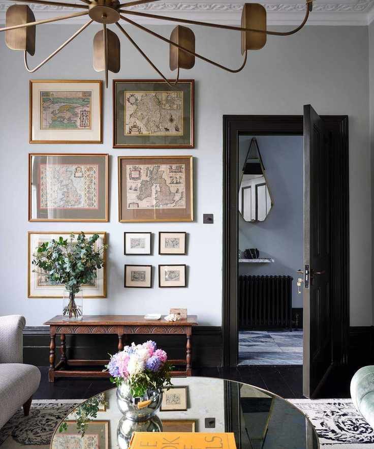 neutral living room with gallery wall and antique table
