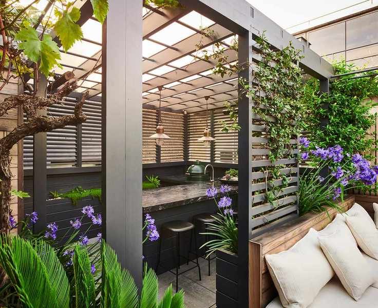 zoned seating areas under a pergola in a backyard