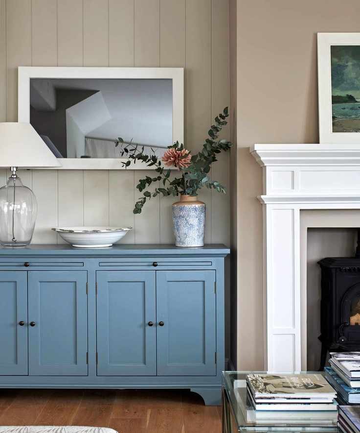 Beige dining room with white fireplace and blue side board - coastal grandmother