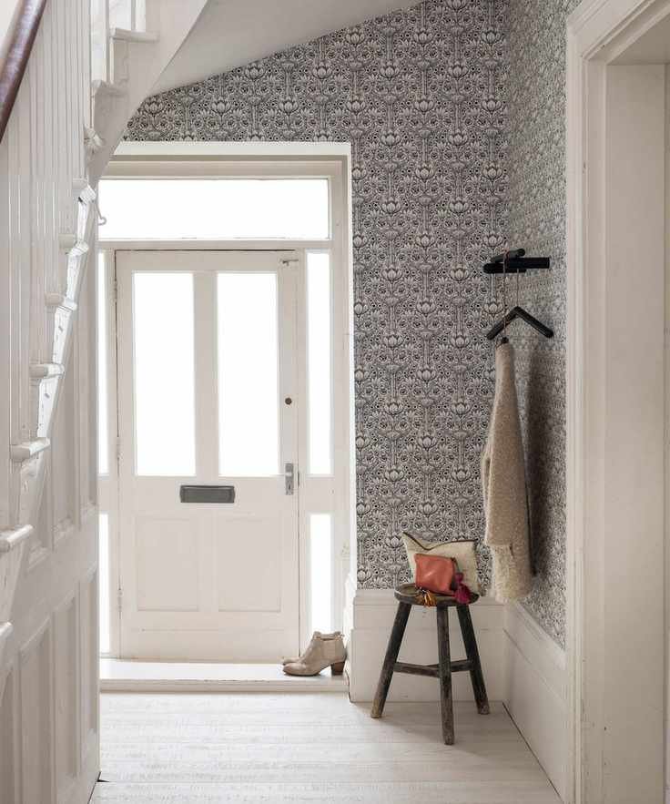 Hall, open ajar white front door, Art Nouveau floral wallpaper, all white painted walls and wooden floorboards