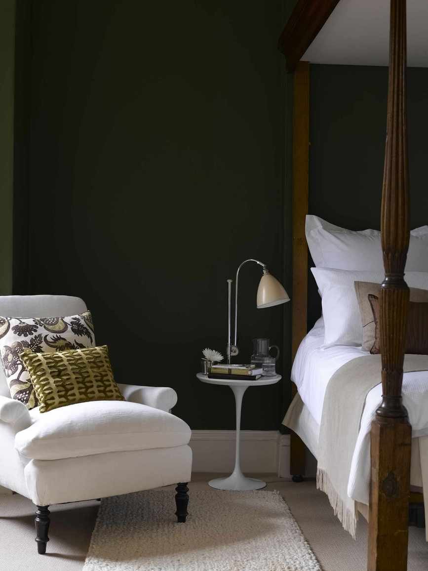grey and white bedroom with dark grey walls