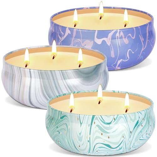 Three citronella candles with three wicks in brightly colored jars