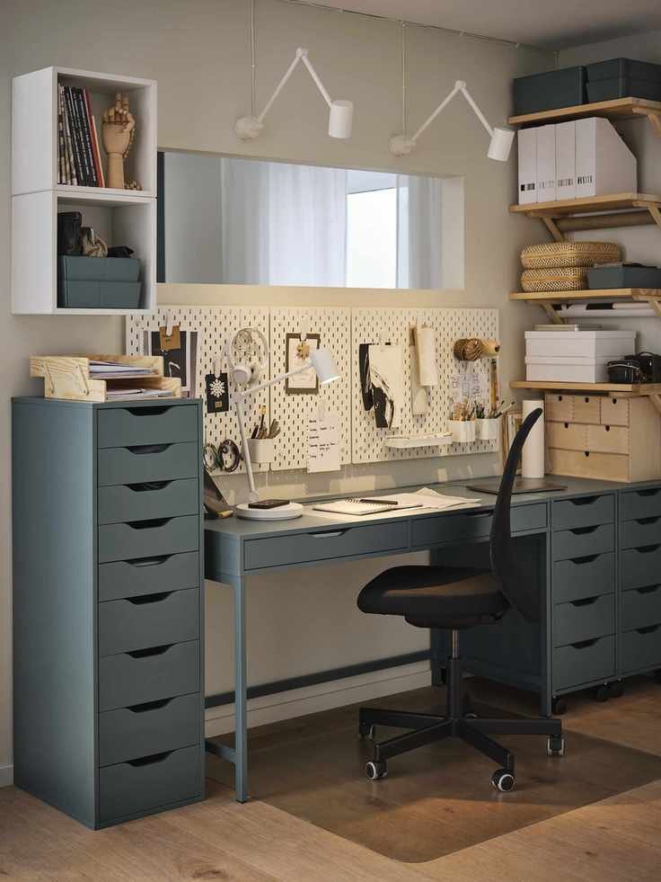 home office with storage units, peg boards, wall lights, shelving, mirror, chair