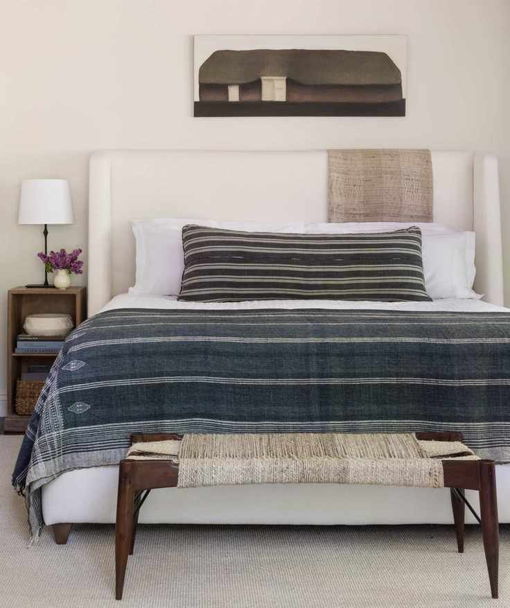 neutral bedroom with art above the bed
