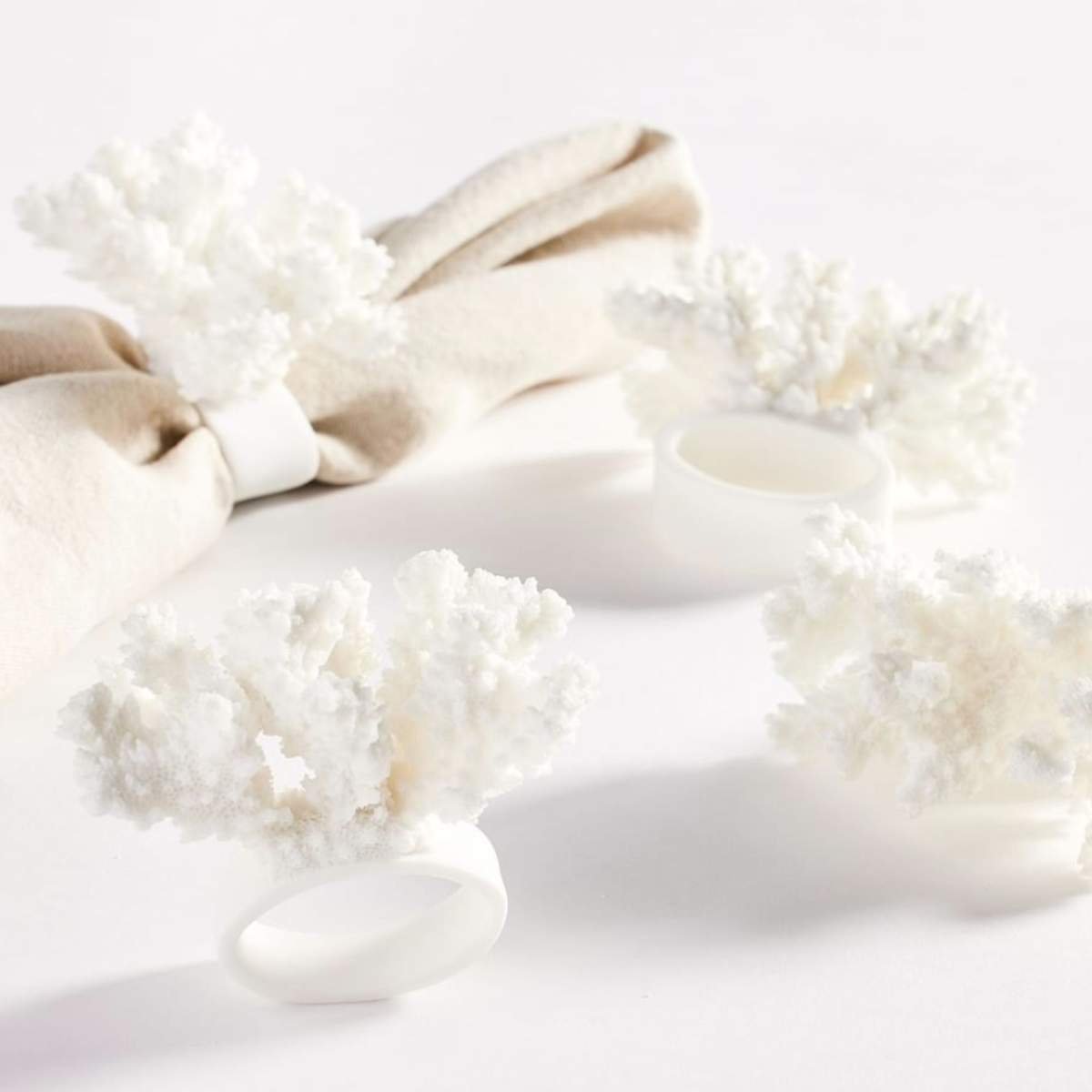 set of four white coral napkin rings