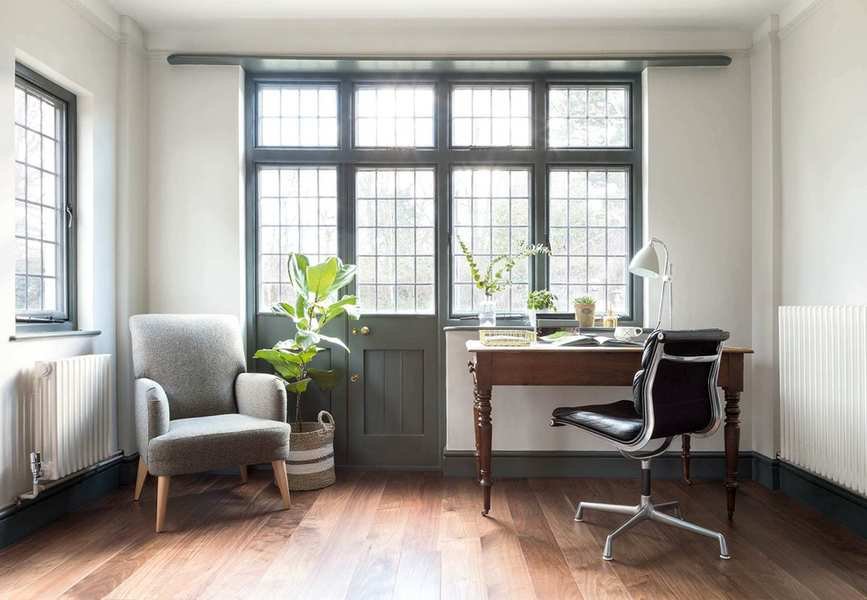 Office with desk, chair and armchair and wood floor