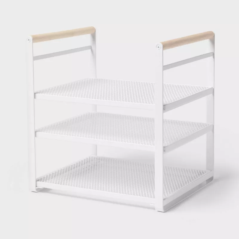 A white metal shelf rising organizer