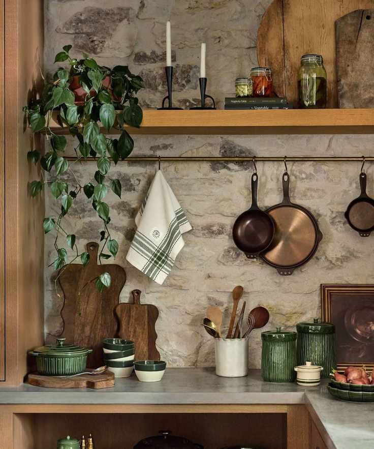 Kitchen with various kitchenware including chopping boards and copper pans
